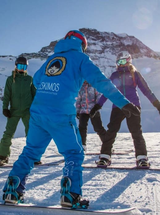 Placeholder: instructor with a snowboard group