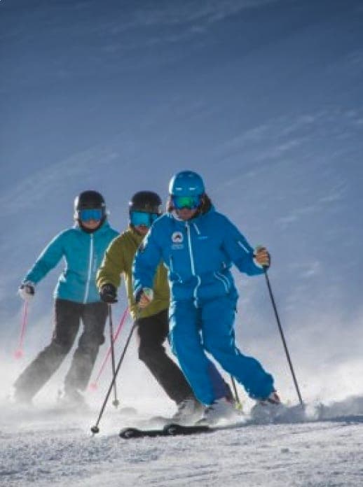 Placeholder: skiers following their instructor