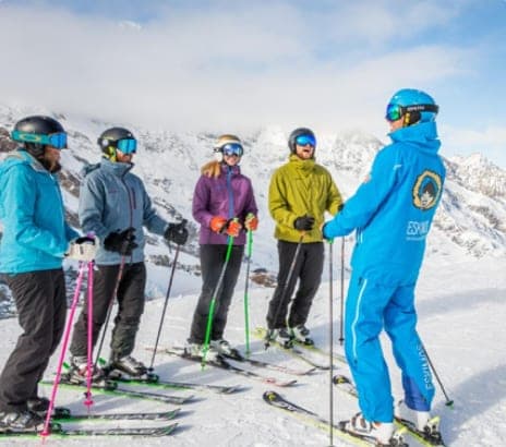 Placeholder: small ski group listening to their instructor