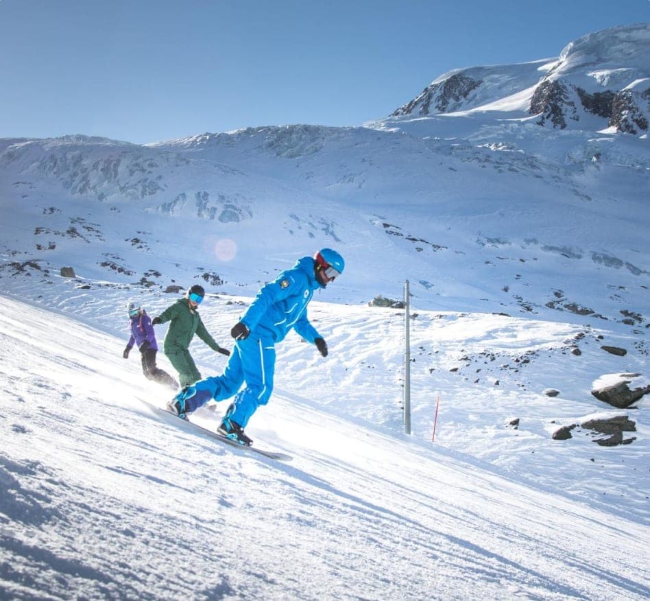 Placeholder: instructor and snowboarders on a glacier slope